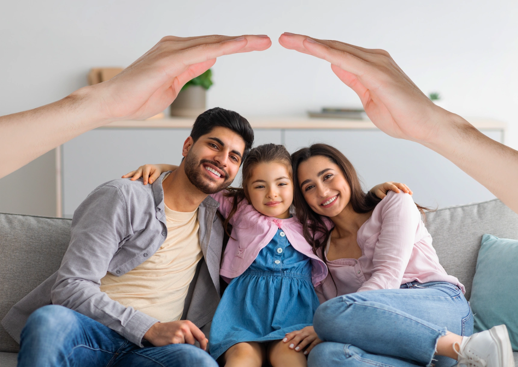 happy-interracial-family-posing-home-hands-roof